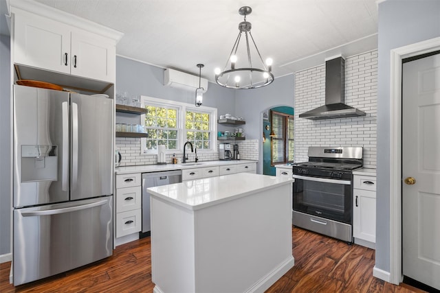 kitchen featuring decorative backsplash, wall chimney range hood, stainless steel appliances, and white cabinetry