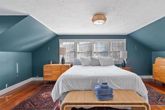 bedroom featuring a textured ceiling, dark hardwood / wood-style floors, and vaulted ceiling