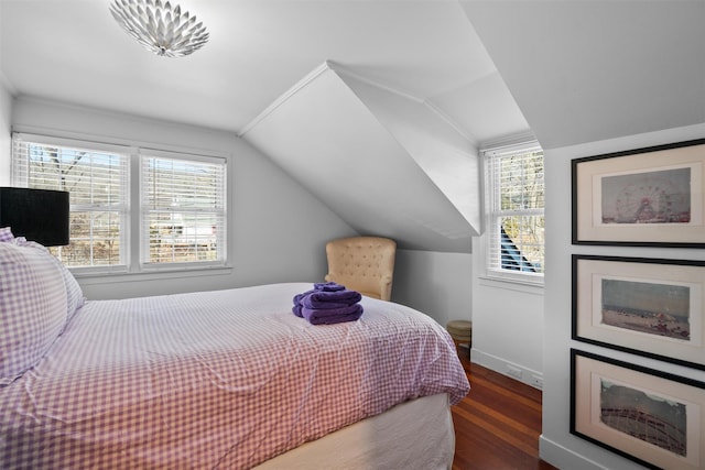 bedroom with dark wood-type flooring and lofted ceiling