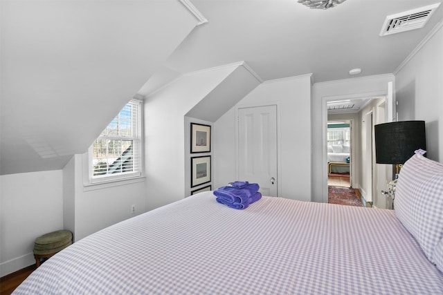 bedroom with dark wood-type flooring, ornamental molding, lofted ceiling, and multiple windows