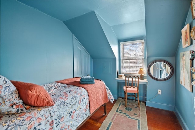 bedroom featuring dark hardwood / wood-style flooring and lofted ceiling