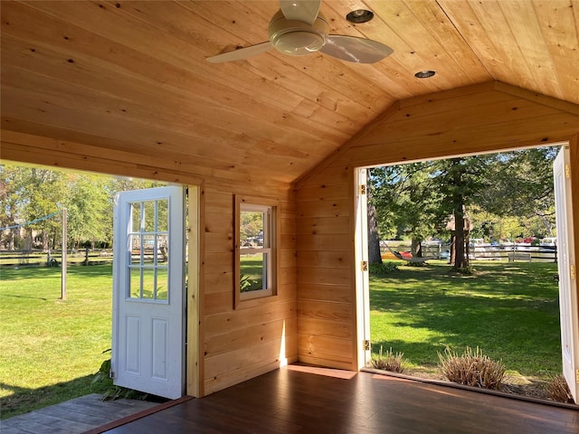 doorway to outside featuring vaulted ceiling, wooden ceiling, hardwood / wood-style flooring, and wood walls