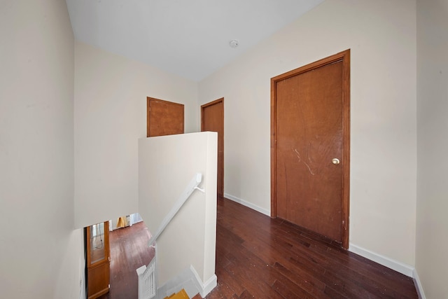 corridor featuring dark hardwood / wood-style flooring