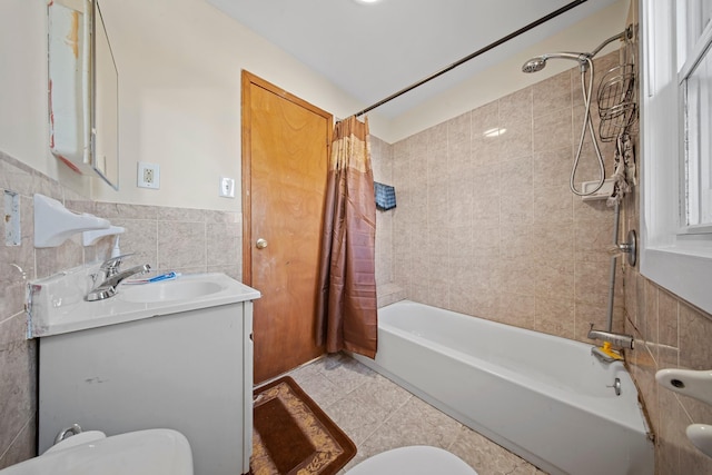 full bathroom featuring vanity, toilet, shower / tub combo, and tile walls