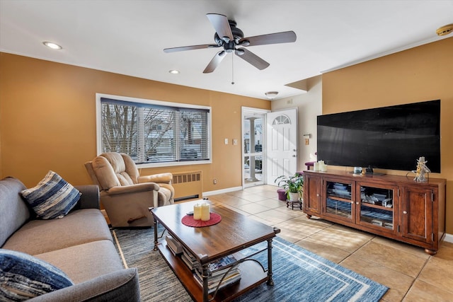 living room featuring radiator heating unit, ceiling fan, and light tile patterned flooring