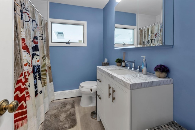 bathroom with curtained shower, wood-type flooring, vanity, baseboard heating, and toilet