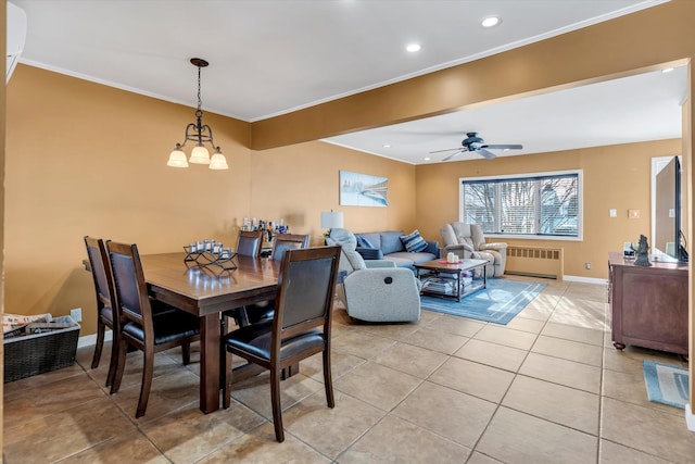 dining area with crown molding, radiator heating unit, ceiling fan with notable chandelier, and light tile patterned floors