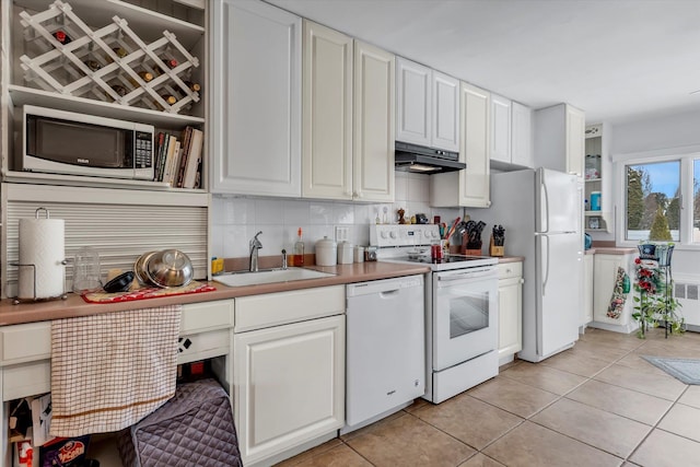 kitchen featuring light tile patterned flooring, white appliances, white cabinetry, and sink