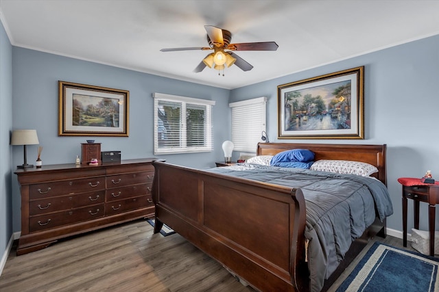 bedroom featuring hardwood / wood-style floors, ornamental molding, and ceiling fan