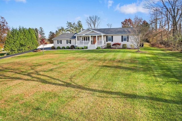 ranch-style home with covered porch and a front yard