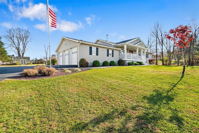 view of front facade featuring a front yard, a porch, and a garage