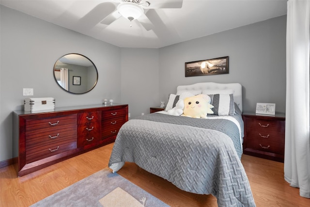 bedroom with ceiling fan and light hardwood / wood-style floors