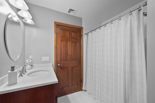 bathroom with tile patterned flooring and vanity