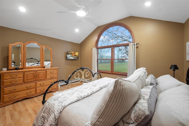 bedroom featuring ceiling fan, wood-type flooring, a baseboard heating unit, and vaulted ceiling