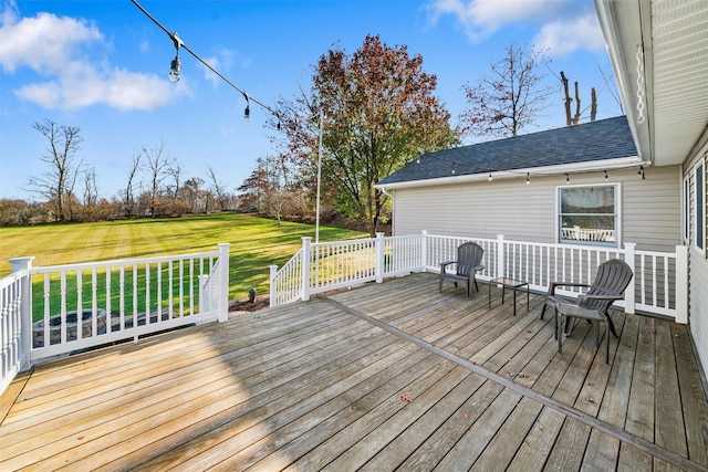 wooden terrace featuring a yard