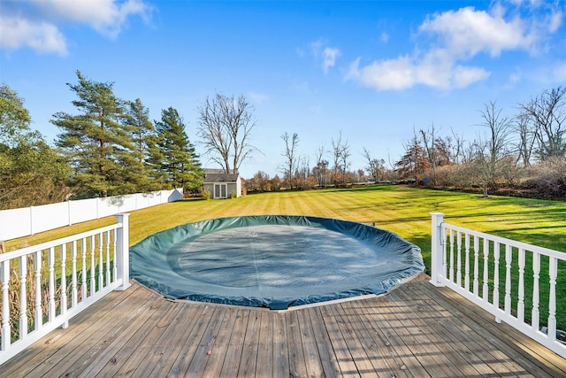 deck featuring a lawn and a storage shed