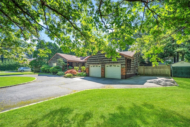 view of front of property featuring a garage and a front lawn