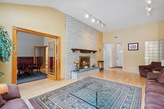 living room featuring a fireplace, hardwood / wood-style flooring, and lofted ceiling