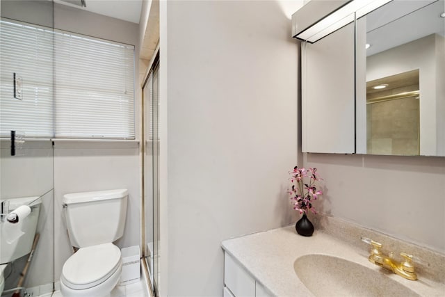 bathroom featuring vanity, toilet, an enclosed shower, and tile patterned flooring