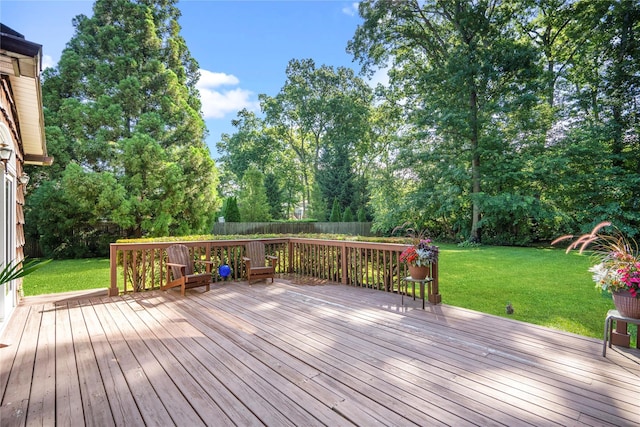 wooden deck featuring a lawn