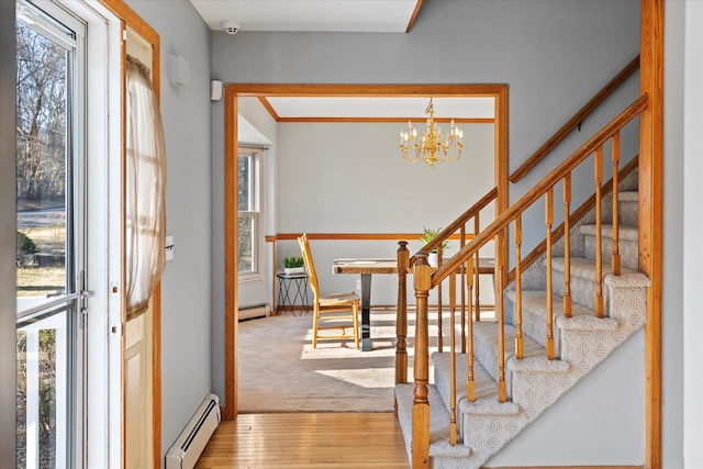 interior space with a notable chandelier, carpet flooring, and a baseboard radiator