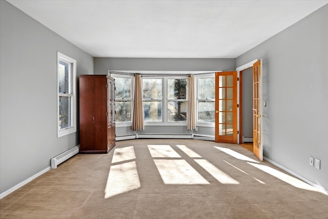 carpeted empty room with baseboard heating