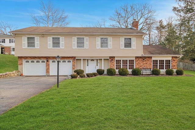 view of front of home featuring a front yard and a garage