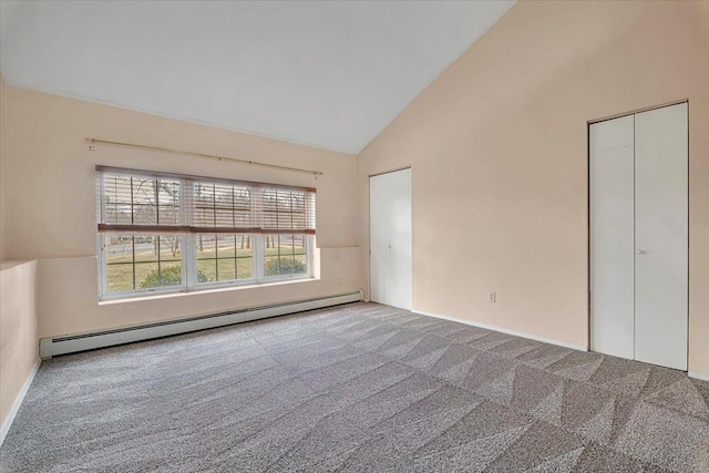 interior space featuring carpet, a baseboard heating unit, and high vaulted ceiling