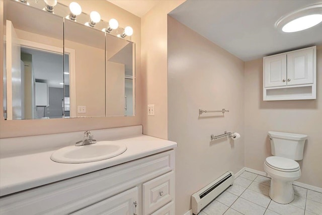 bathroom featuring toilet, vanity, a baseboard heating unit, and tile patterned floors