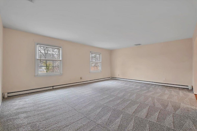 unfurnished room featuring baseboard heating and light colored carpet