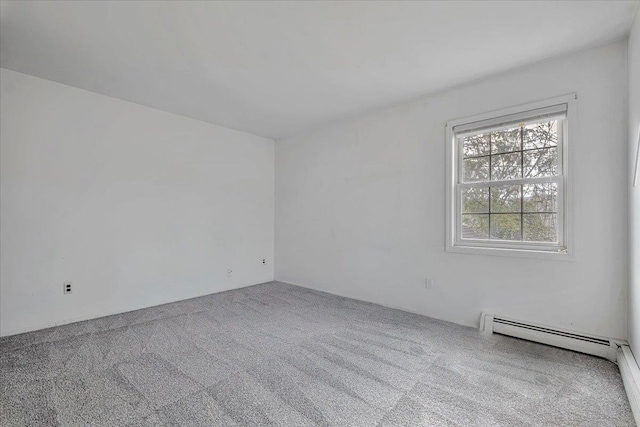 empty room with baseboard heating and carpet floors