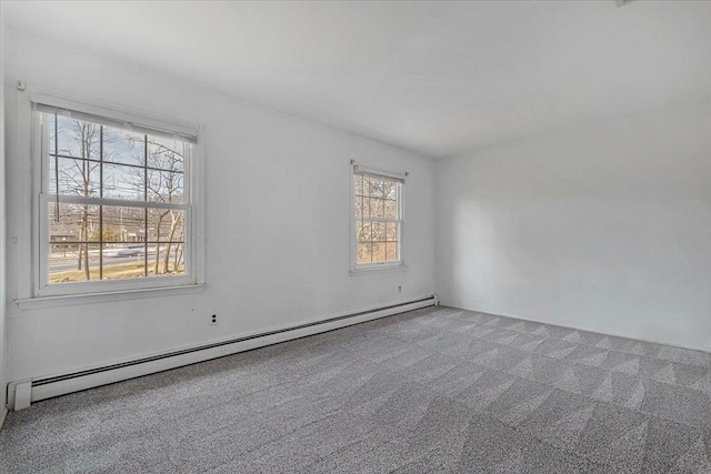 empty room featuring carpet floors and a baseboard heating unit