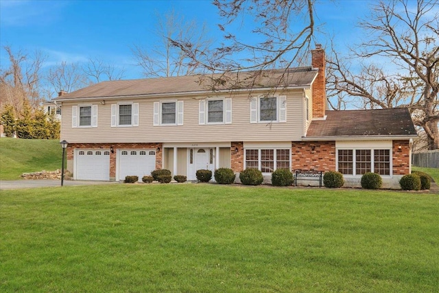 view of front of home with a garage and a front lawn