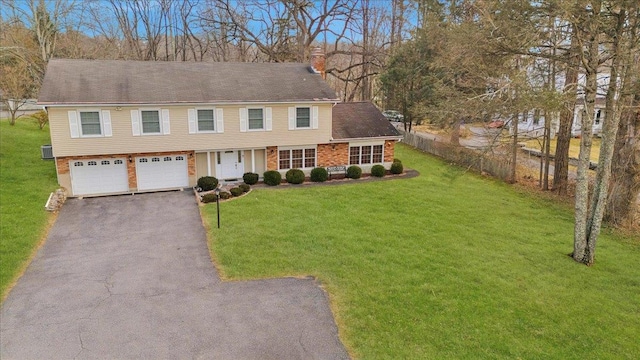 view of front of house featuring a garage and a front lawn