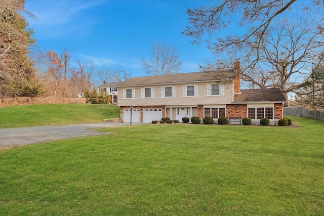 view of front of property with a garage and a front yard