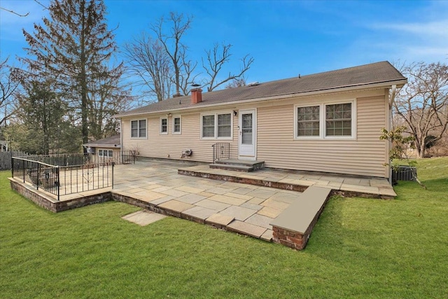 back of property with a patio area and a yard