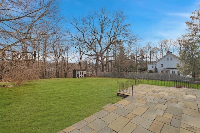 view of yard with a storage unit and a patio