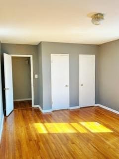 unfurnished bedroom with hardwood / wood-style flooring