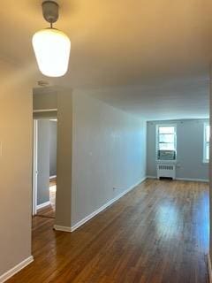 interior space featuring dark hardwood / wood-style floors and radiator heating unit