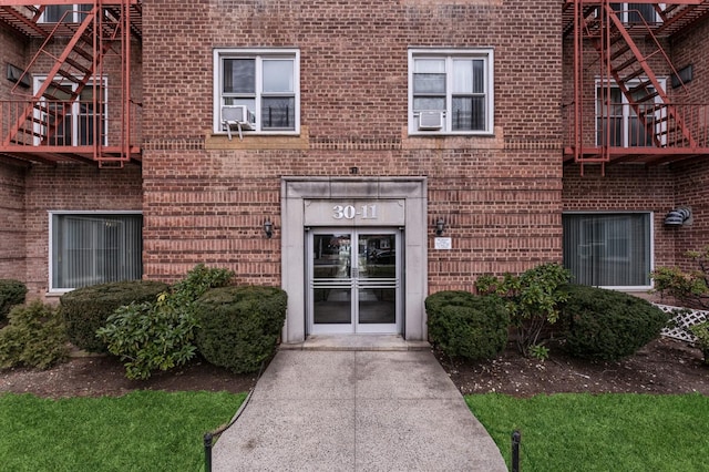 view of exterior entry with brick siding