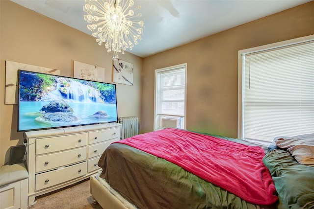 bedroom featuring radiator, cooling unit, an inviting chandelier, and light colored carpet