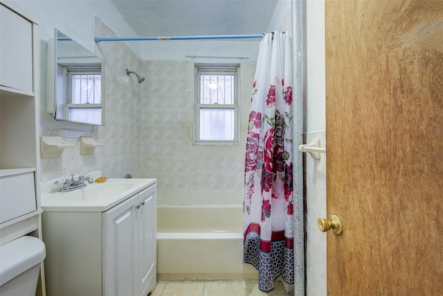 full bathroom featuring tile patterned flooring, vanity, tasteful backsplash, toilet, and shower / bath combo with shower curtain