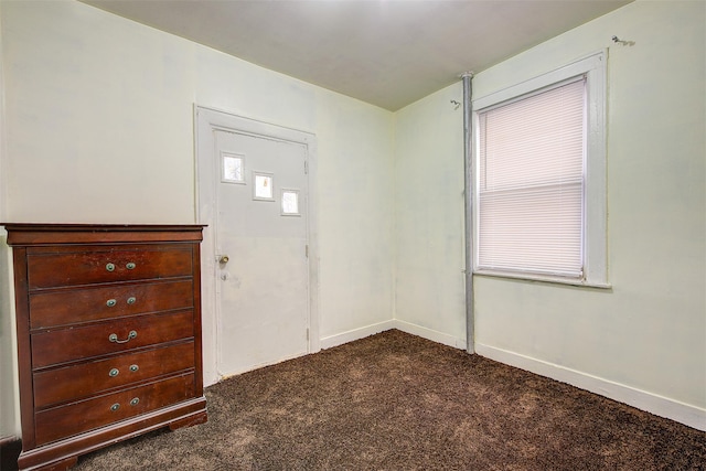 entrance foyer with dark carpet