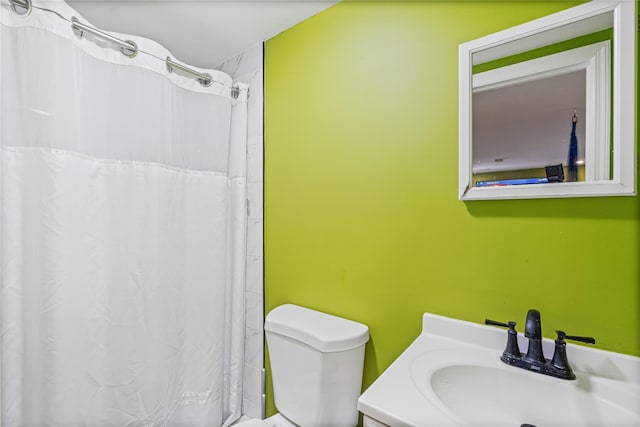 bathroom with vanity, a shower with shower curtain, and toilet