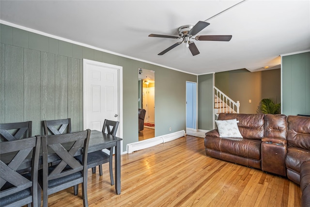 living room featuring hardwood / wood-style flooring, ornamental molding, and ceiling fan