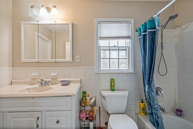 full bathroom featuring vanity, shower / bath combo with shower curtain, and toilet