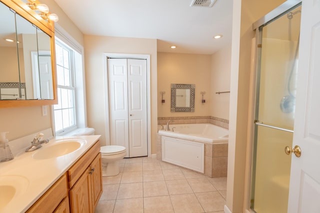 full bath featuring tile patterned floors, a stall shower, a garden tub, and a sink