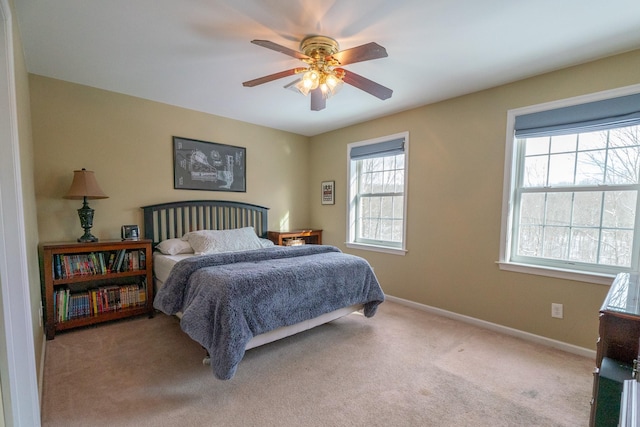 carpeted bedroom with baseboards and ceiling fan