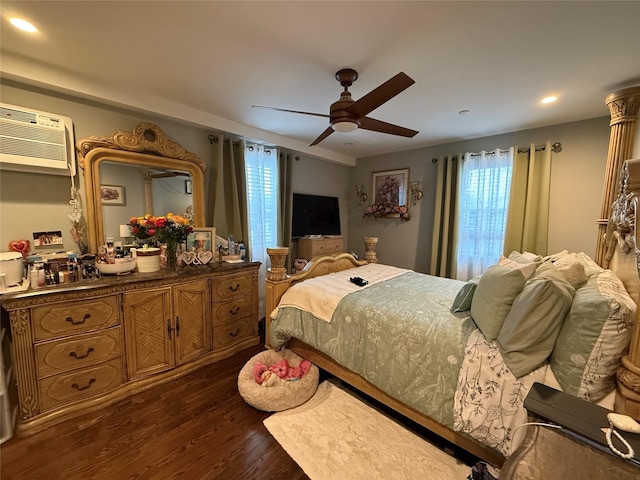 bedroom with ceiling fan, a wall mounted AC, and dark wood-type flooring