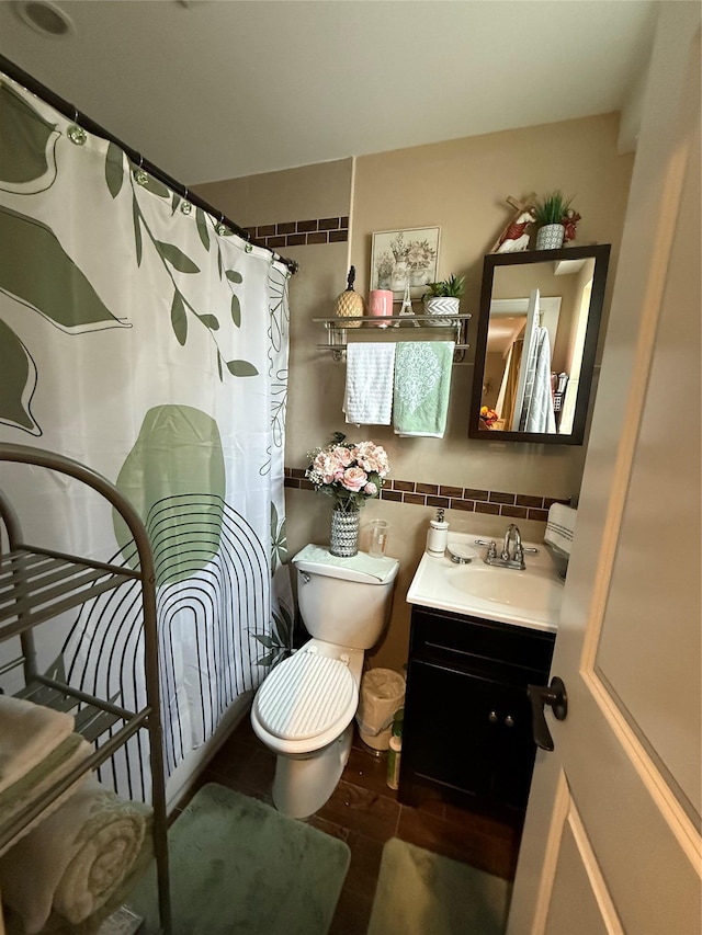 bathroom with hardwood / wood-style flooring, backsplash, toilet, and vanity